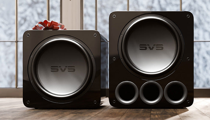 17-Ultra R|Evolution Series Holiday Image, red bow on top of the sealed box subwoofer with a snowy background outside of the windows.